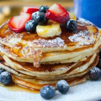 Golden Pancakes with Fresh Blueberries · 3 Fluffy golden pancakes with fresh blueberries. Served with a side of syrup and butter.