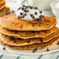 Golden Pancakes with Chocolate Chips · 3 Fluffy golden pancakes topped with warm chocolate chips. Served with a side of syrup and b...
