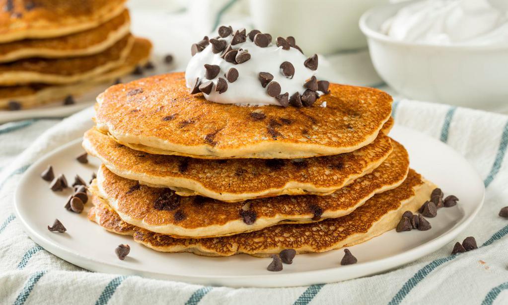 Golden Pancakes with Chocolate Chips · 3 Fluffy golden pancakes topped with warm chocolate chips. Served with a side of syrup and butter.