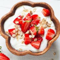 Greek Yogurt with Strawberries, Granola and Honey · Creamy Greek yogurt topped, locally grown strawberries, homemade granola and drizzled with h...