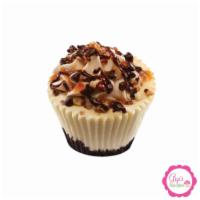 Turtle Cheesecake · Turtle cheesecake topped with caramel buttercream and sprinkled with pecans and chocolate ch...