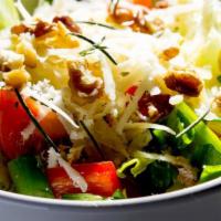 Greek Salad · Mix of fresh tomatoes, cucumbers, onions, parsley, sliced black olives, feta cheese and bast...