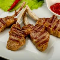 4 Piece Lamb Chops · Includes salad and side dish.