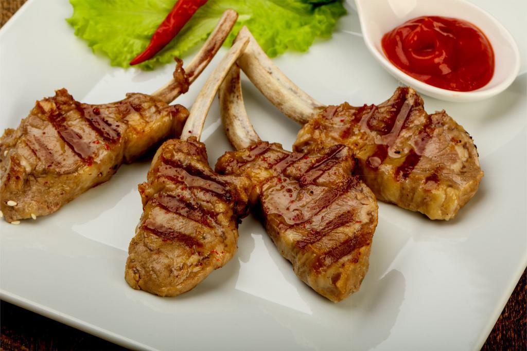 4 Piece Lamb Chops · Includes salad and side dish.