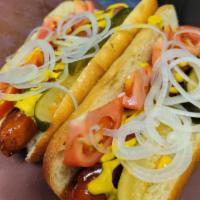 Chicago Style Hot Dog · Topped with homemade spicy pickle spear, tomato onion and yellow mustard.