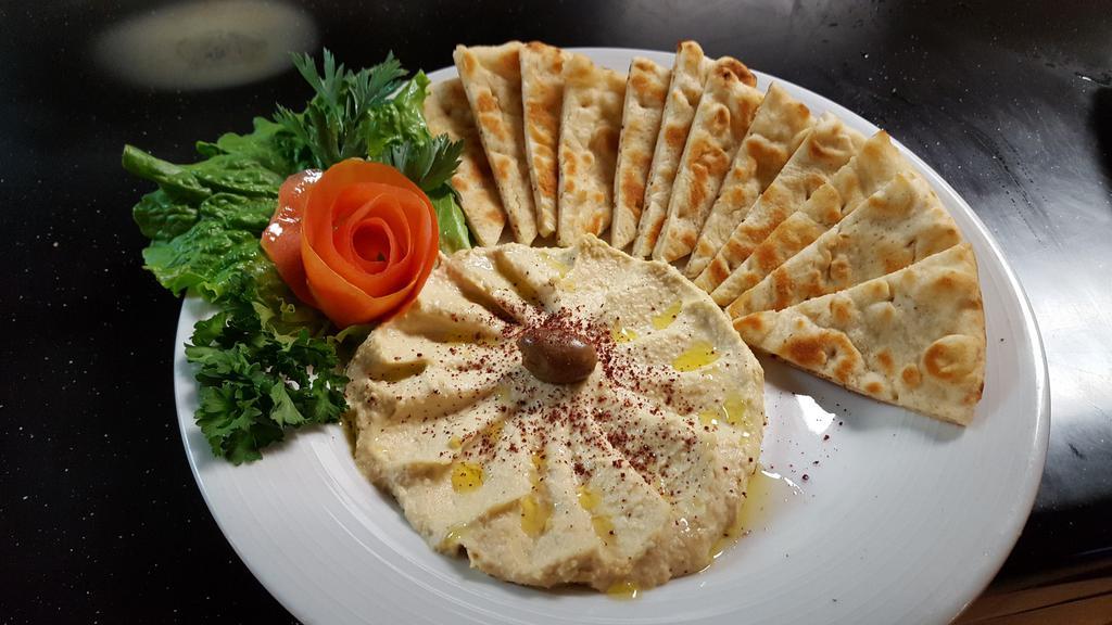 Classic Hummus · Basil’s famous classic hummus made from fresh chickpea’s, extra virgin olive oil, fresh garlic and tahini, topped with diced tomato.