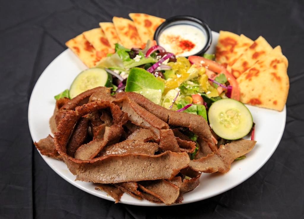 Gyros Salad · Generous portion of grilled gyros meat with fresh greens, tomato, cucumber, unpitted calamata olives (with seeds), pepperoncini, feta cheese and warm pita bread, served with side of Basil’s tzatziki sauce and Greek dressing.