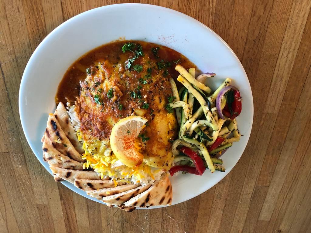 Tilapia Bandarri · Baked house marinated tilapia, topped with basil’s tomato sauce and served with grilled zucchini, yellow squash and fresh pita bread, and served with saffron basmati rice.