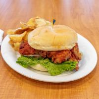 Buffalo Chicken Sandwich · Tender chicken breast, hand breaded and tossed with buffalo sauce with lettuce and tomato, s...