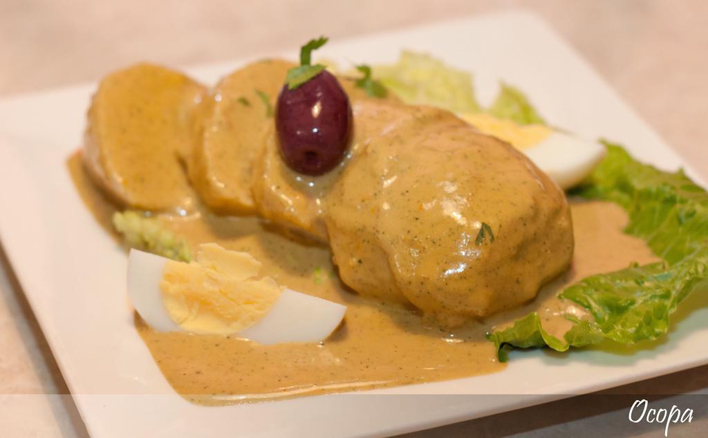 Ocopa · Sliced baked potatoes topped with Peruvian spicy cream sauce. 