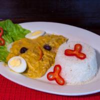 Aji de Gallina · Shredded chicken with rice and potatoes, with a creamy spicy sauce.