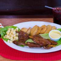 Anticucho Especial Combo · Served with three diced cow's heart, salad, baked potato, Peruvian corn and Peruvian spicy c...