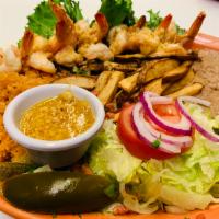 Camarones a la Mojo De Ajo · Jumbo shrimp cooked with butter and fresh garlic served with rice, beans, salad, french frie...