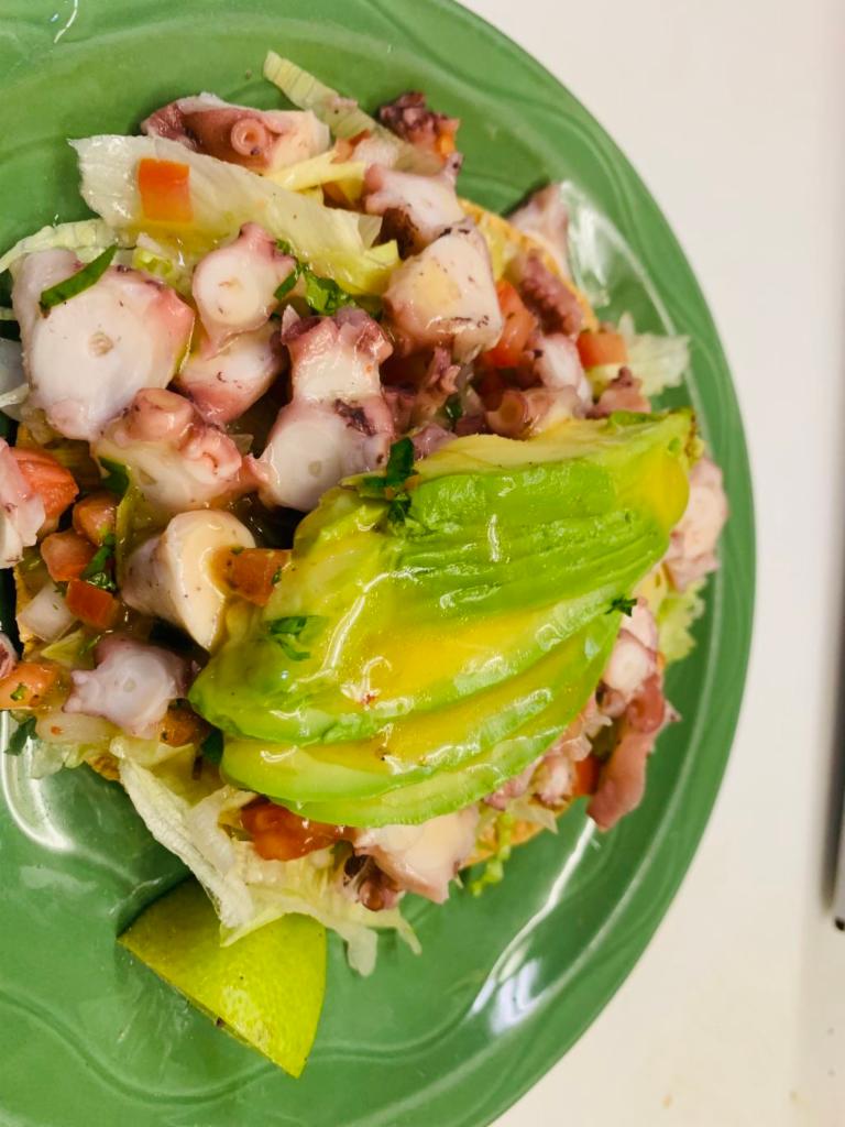 Tostada de Pulpo · Tostada with diced tomatoes, onion and cucumber octopus.