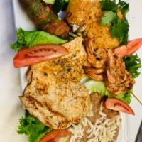 Mar y Tierra Plate · Chicken and shrimp with rice and beans with cheese on top, and lettuce and fried Chili's pep...