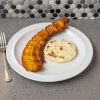 Chicharron con Arepa · Pork skin with corn cake.