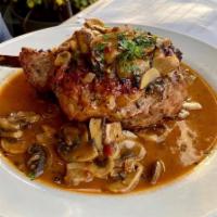 Veal Chop Valdostano · Pounded, breaded and pan-fried topped with prosciutto, mozzarella in a Marsala mushroom sauce.