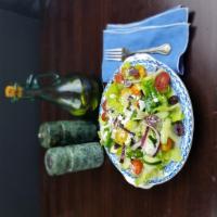 Greek Romaine Salad · Romaine lettuce with tomatoes, cucumbers, onions, Kalamata olives, vegan feta, and choice of...