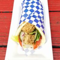 Grilled Tempeh Souvlaki Pita · Marinaded local tempeh seasoned with our secret herbs and spices, skewered, and flame-grille...