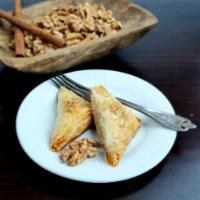 Baklava · Spiced nuts in flaky phyllo triangles, drenched in sweet agave syrup. (2 pieces per oder)