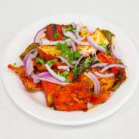 Paneer Tikka Dry · Cottage cheese cubes cooked in clay oven sauteed with bell papers and chilly sauce.