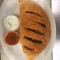 Classic Greek Calzone · Feta cheese, olives, gyro meat, onion, tomatoes and pesto.