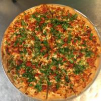 Tandoori Chicken Pizza · Tandoori chicken, bell peppers, onion, fresh ginger, garlic and cilantro. Pizza comes with c...