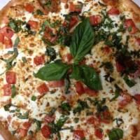 Margherita Pizza · Lite fresh garlic, Roma tomatoes, olive oil, mozzarella, and fresh basil.