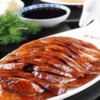 Beijing Duck · A young seasoned duckling, slowly grilled until crispy and golden. The delicate skin is firs...