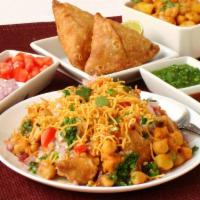 Somasa Chat · crushed crunchy potato stuffed samosa taht is then topped with channa/chickpeas, yoghurt, sw...