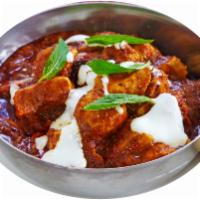 Tikka Masala · BBQ Protein cubes cooked in red creamy yogurt sauce with fresh herbs and spices.