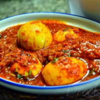 Egg Curry · Boiled egg cooked in a tomato gravy, with onions, ginger garlic paste, and garam masala.