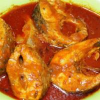 Fish Pulusu · Traditional south Indian style fish cooked in onions, tomato, and spicy tamarind gravy.