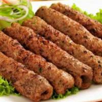 Lamb Seekh Kebab · Sizzling lamb, lentils and spices and skewered.