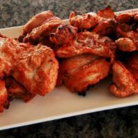 Tandoori Chicken · Chicken marinated in yogurt, lemon juice, fresh herbs and spices and BBQ.