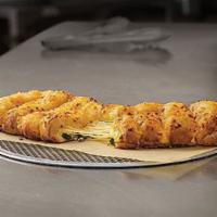 Stuffed Cheesy Bread · Oven-baked breadsticks stuffed with cheese and covered in a blend of cheeses made with 100% ...