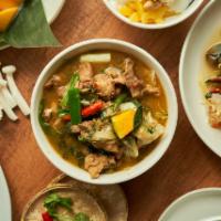 Gaeng Om (Lao Style Soup) · Dark meat chicken, cabbage, Thai eggplant, and dill in spicy dark broth flavored with dried ...