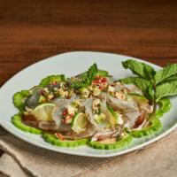 Goong Chae Num Pla (Raw Shrimp Salad) · Shrimp marinated in fish sauce, chilies, and lime juice. Served w/bitter melon and mint leav...
