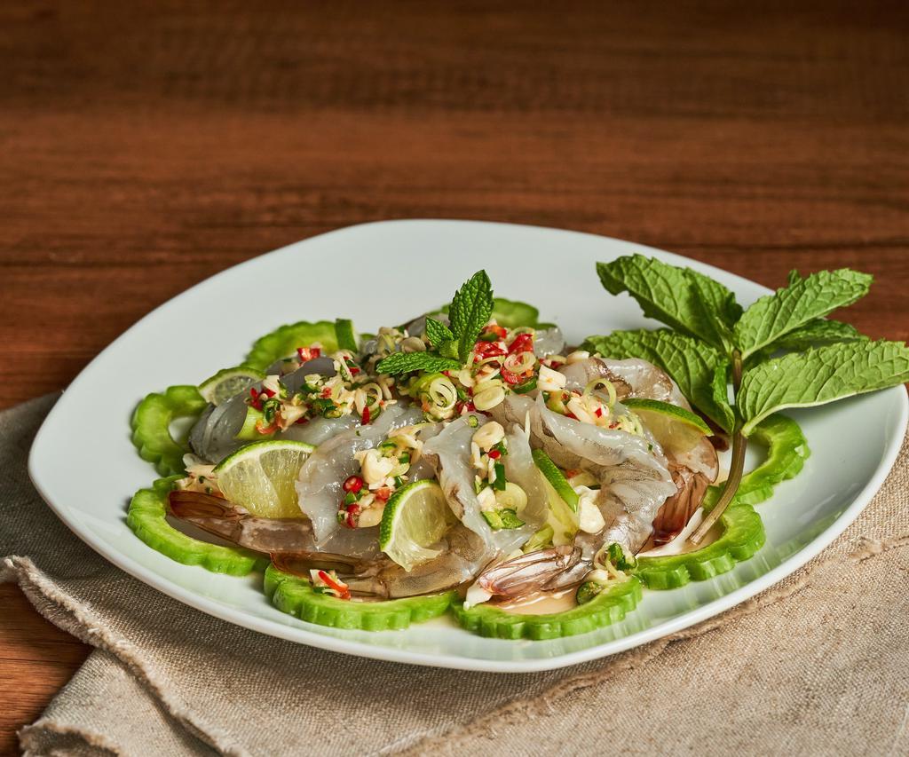 Goong Chae Num Pla (Raw Shrimp Salad) · Shrimp marinated in fish sauce, chilies, and lime juice. Served w/bitter melon and mint leaves.