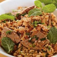 Larb Moo (Isan Pork) · Mint, Thai chilies, red onion, roasted rice powder, fish sauce, and lime juice