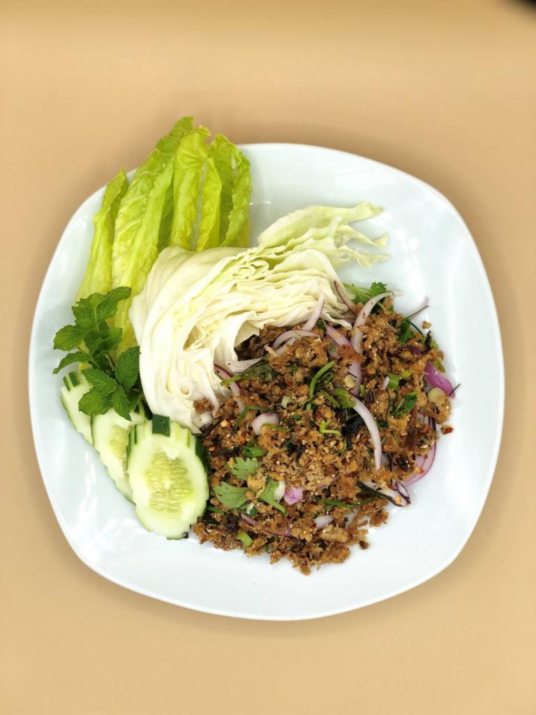 Larb Moo Kua (Phayao Spice Pork) · A Northern Thai favorite: minced pork, liver, and skin with roasted spices from Phayao, including shrimp paste, Thai chilies, and wild Northern Thai mah kwan peppercorns