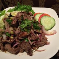 Nuer Num Tok (Steak) · Thai chilies, roasted rice powder, kaffir lime leaf, mint, fish sauce, red onion, cilantro, ...