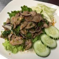 Moo Num Tok (Pork) · Thai chilies, roasted rice powder, kaffir lime leaf, mint, fish sauce, red onion, cilantro, ...