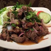 Yum Nuer Salad · Grilled sirloin steak, lemon grass, kaffir lime leaf, red onion, scallion, cilantro, mint, c...
