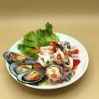 Yum Talay (Seafood) · Mixed seafood (shrimp, squid, and mussels) with onion, tomato, chilies, fish sauce, and lime...