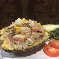 Kow Pad Sapparod (Pineapple Fried Rice) · Fried rice w/ egg, Chicken, Shimp, cashew nuts, raisins, and scallions