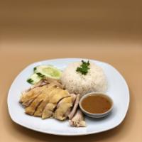 Kow Mun Gai (Chicken Over Rice) · The Thai comfort food classic: Steamed chicken over ginger rice w/ Thai herbal ginger sauce