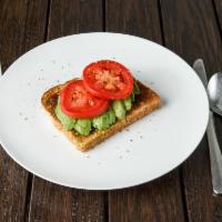 Avocado Toast · Perfectly ripened avocado, laid gracefully on toasted 12-grain bread, topped with tomatoes a...