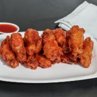 Buffalo Wings American · 10 pieces. Fried chicken wings smothered in Buffalo sauce.