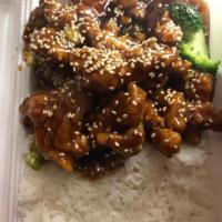 H2. Sesame Chicken · Chunk of chicken fried crispy gold brown with light sweet sauce and sesame on top. With rice.